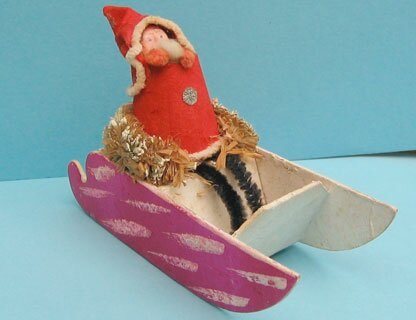 31b: Japanese Santa in sleigh, plaster face, chenille arms and legs, paper hood/coat,